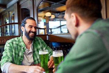 Image showing male friends drinking green beer at bar or pub