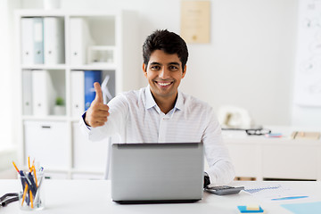 Image showing businessman showing thumbs up at office