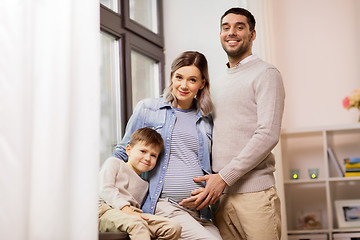 Image showing happy family with pregnant mother at home