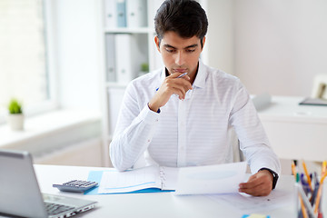 Image showing businessman working with papers at office