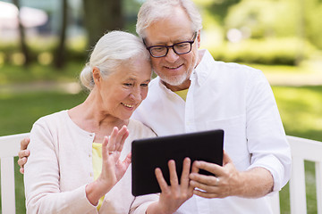 Image showing senior couple with video chat on tablet pc at park