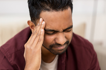 Image showing close up of man suffering from head ache at home