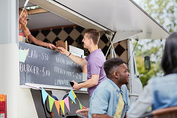 Image showing customer paying money to saleswoman at food truck