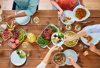 Image showing group of people eating at table with food