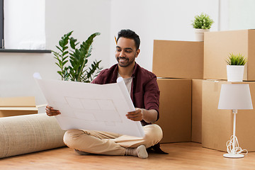 Image showing man with blueprint and boxes moving to new home