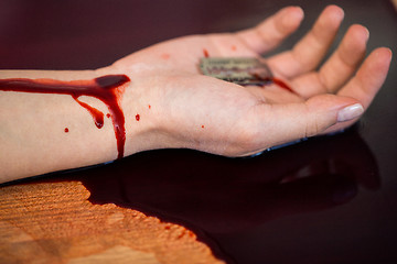 Image showing dead woman hand in blood on floor at crime scene