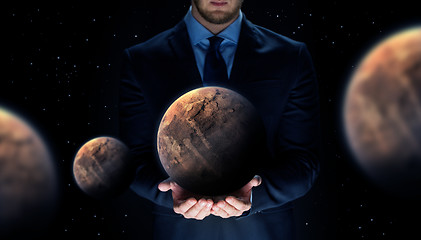 Image showing close up of businessman with planet hologram