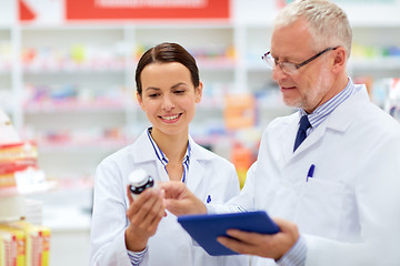 Image showing apothecaries with tablet pc and drug at pharmacy