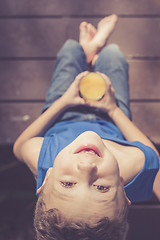 Image showing one boy is sitting with a glass of juice