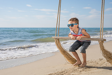 Image showing One happy little boy playing on the beach at the day time.