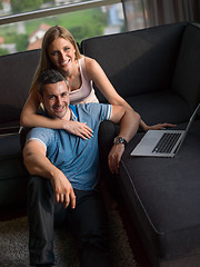 Image showing Attractive Couple Using A Laptop on couch