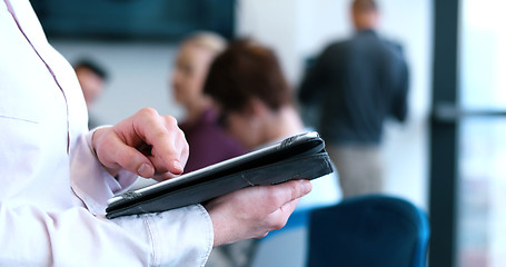 Image showing Portrait of  smiling casual businesswoman using tablet  with cow