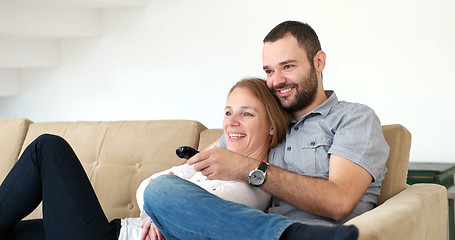 Image showing senoior couple watching tv in modern villa