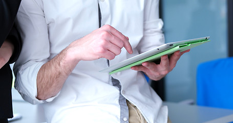 Image showing Two Business People Working With Tablet in startup office