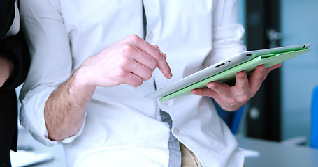 Image showing Two Business People Working With Tablet in startup office