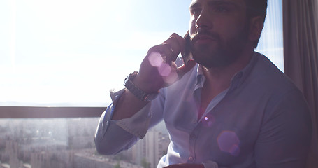Image showing Business Man Talking On Cell Phone At Home
