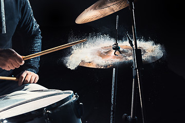 Image showing Drummer rehearsing on drums before rock concert. Man recording music on drum set in studio