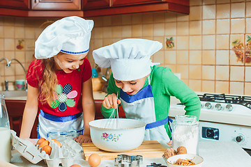 Image showing happy family funny kids are preparing the dough, bake cookies in the kitchen