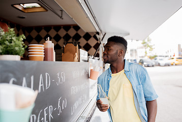 Image showing african american man with drink at food truck