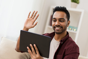 Image showing happy man with tablet pc having video chat at home