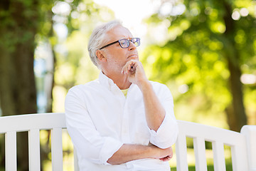 Image showing thoughtful senior man at summer park