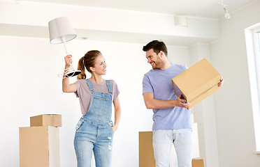 Image showing couple with boxes and lamp moving to new home