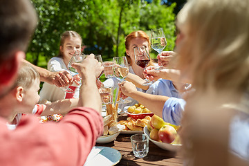 Image showing happy family having dinner or summer garden party