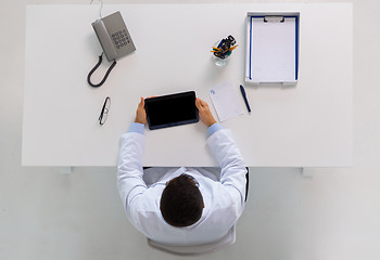 Image showing doctor with tablet pc and prescription at clinic