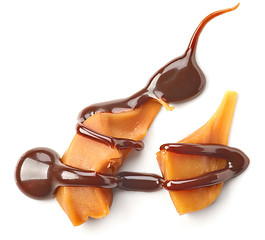 Image showing Pieces of caramel with chocolate sauce