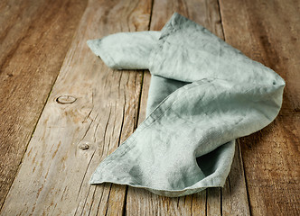 Image showing linen napkin on wooden background