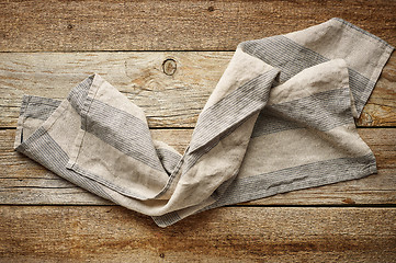 Image showing linen napkin on wooden background