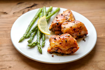 Image showing Plate of grilled chicken meat and asparagus