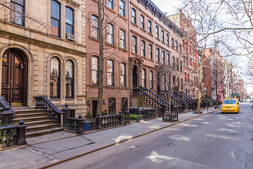 Image showing Scenic tree lined street of historic brownstone buildings in the West Village neighborhood of Manhattan in New York City, NYC USA