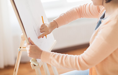 Image showing artist with pencil drawing picture at art studio