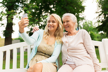 Image showing daughter and senior mother taking selfie at park