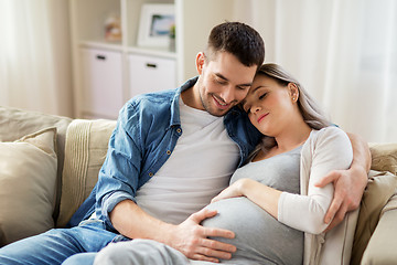 Image showing man hugging pregnant woman at home