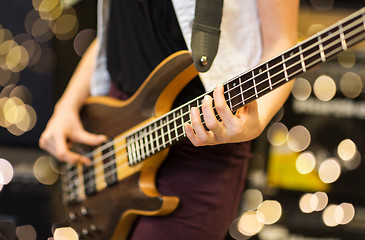 Image showing close up of musician with guitar at music studio