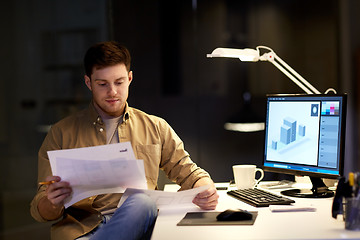 Image showing designer with papers working at night office