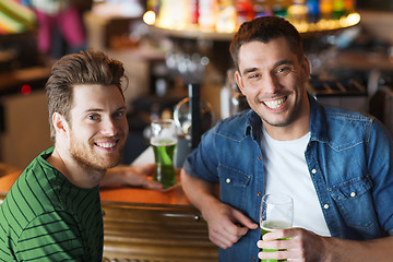 Image showing male friends drinking green beer at bar or pub