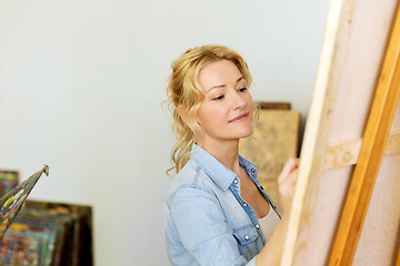 Image showing woman with easel drawing at art school studio