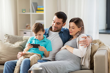 Image showing happy family with smartphone at home