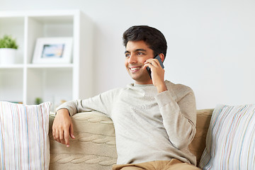 Image showing happy man calling on smartphone at home