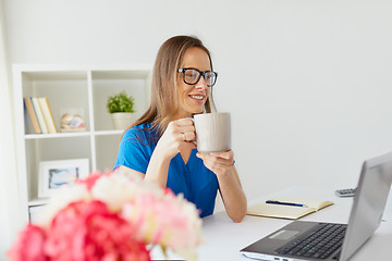 Image showing woman with laptop and coffee at home or office