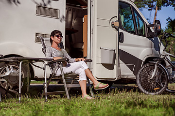 Image showing Woman resting near motorhomes in nature. Family vacation travel,