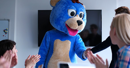 Image showing boss dresed as bear having fun with business people in trendy of