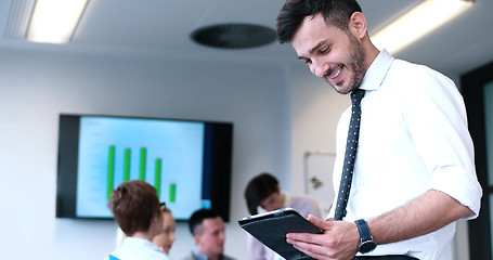 Image showing Businessman using tablet in modern office