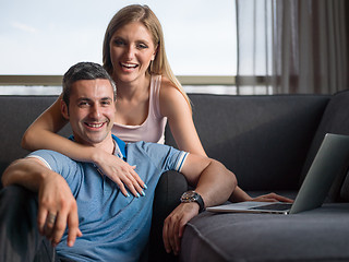 Image showing Attractive Couple Using A Laptop on couch