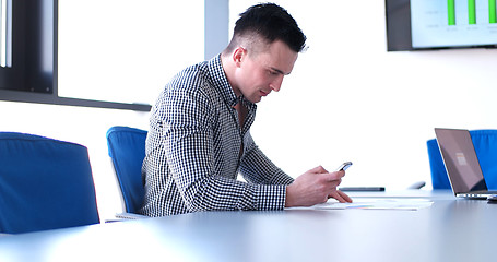 Image showing Senior businessman  using cell phone at  stratup office