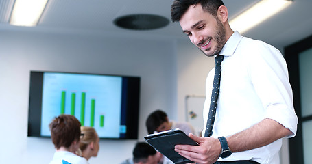 Image showing Businessman using tablet in modern office