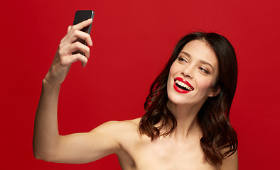 Image showing beautiful woman taking selfie with smartphone